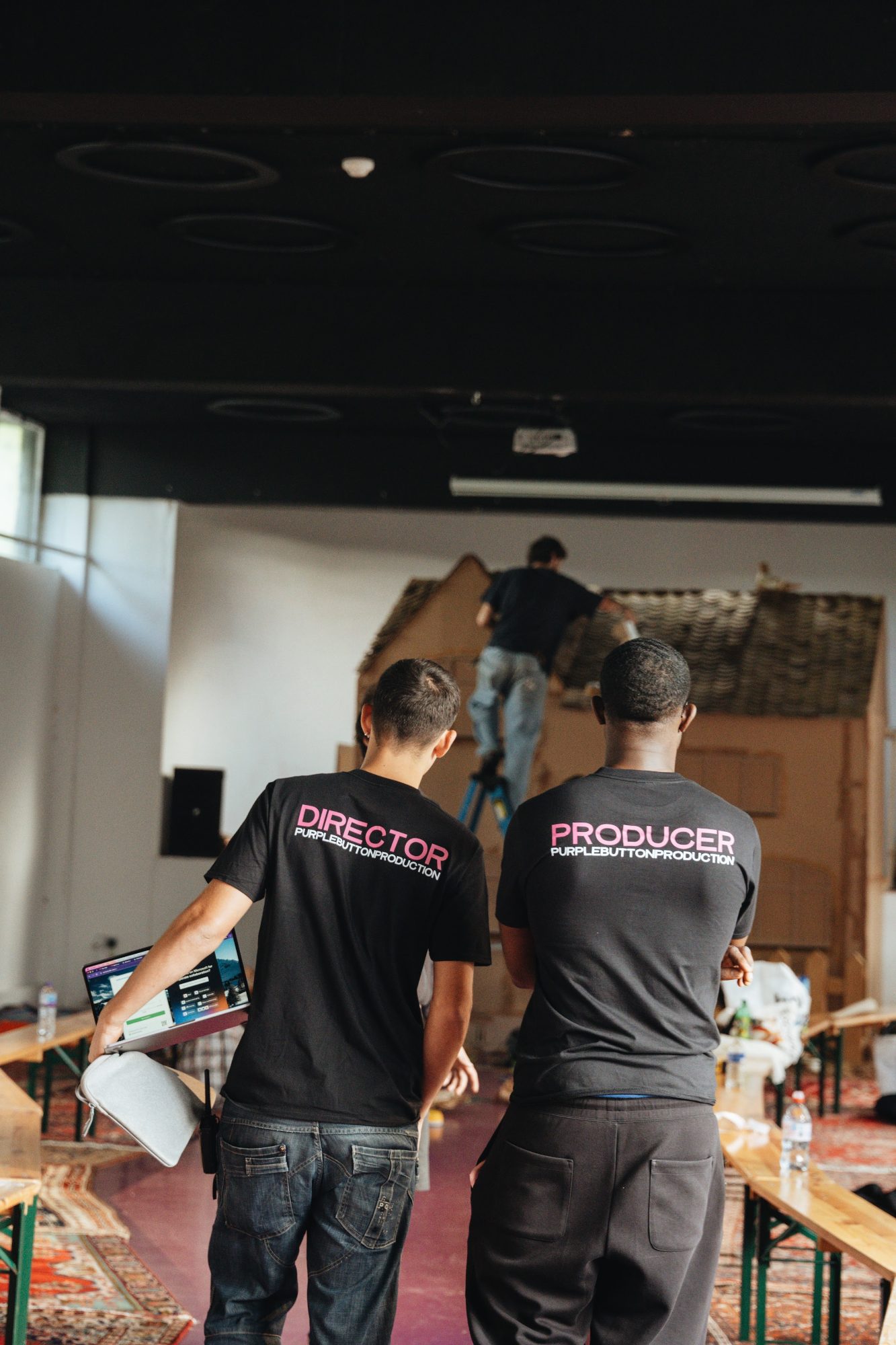 Felix Allen and Enys Obeng in Director and Producer t-shirts on set